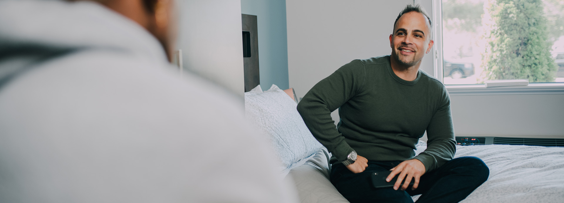 Two patients sitting on their beds chatting